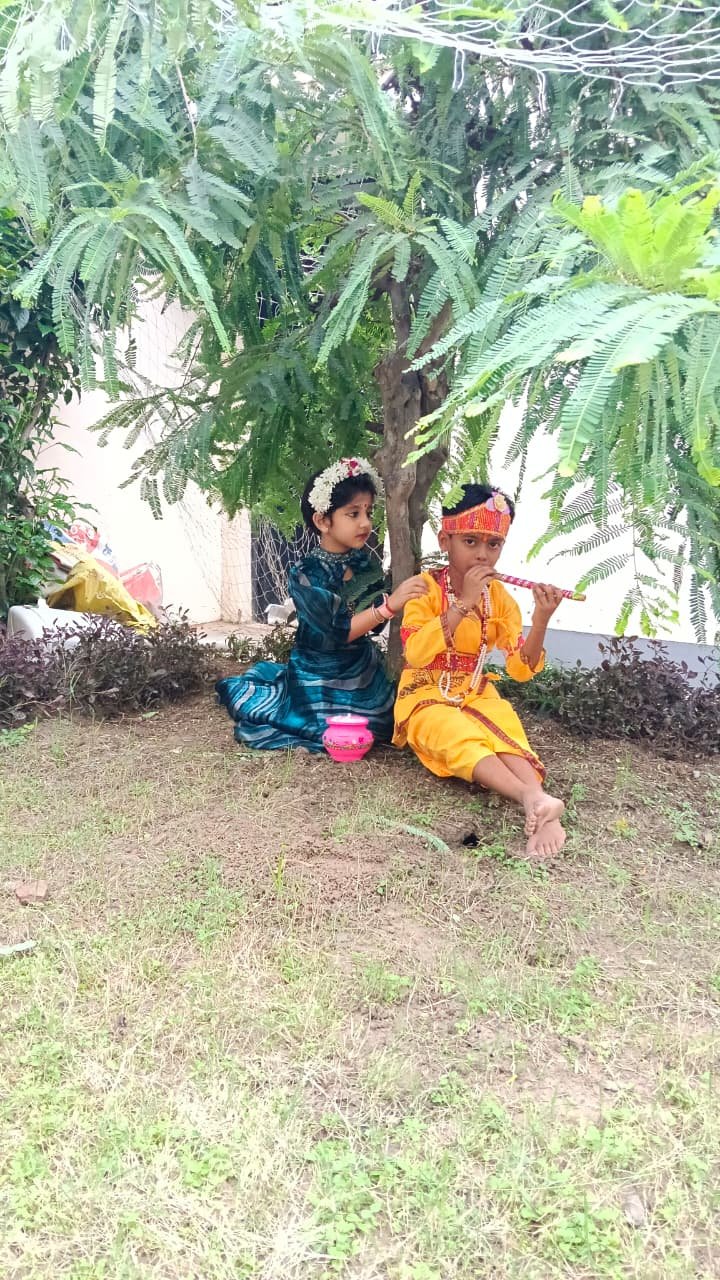 Children dressed as Krishna and Radha during a school celebration