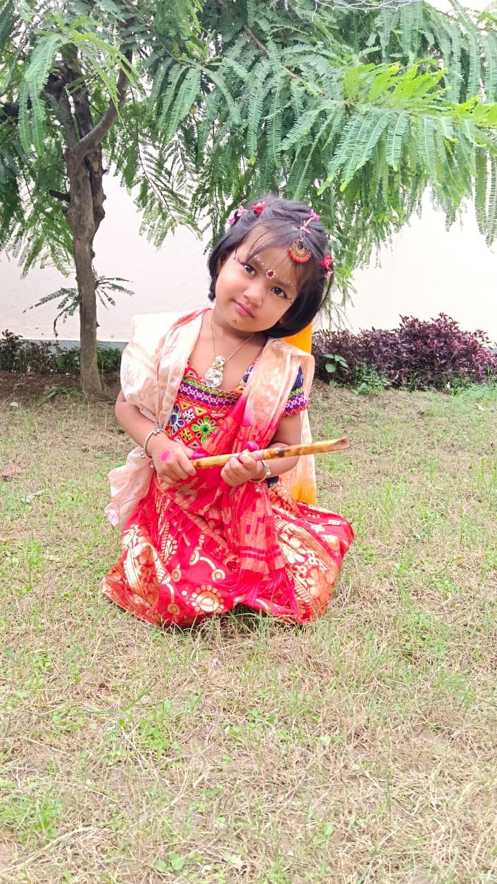 A student in colourful traditional dress at the school celebration